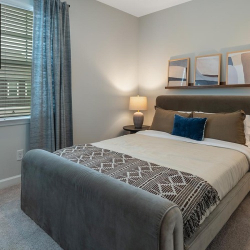 a bedroom with a bed and lamps
